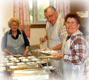 A photograph of volunteers preparing lunch at one of the centers.
